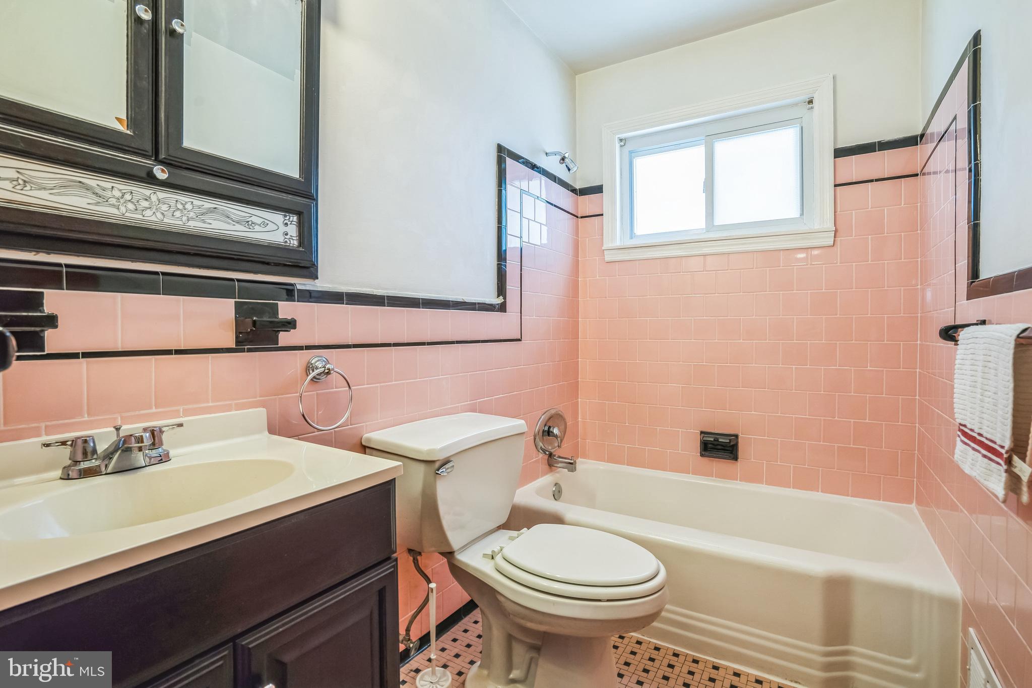 7911 35th Street Rosedale, MD 21237 - Photo 21 of 30 a bathroom with a sink a toilet a mirror and bathtub