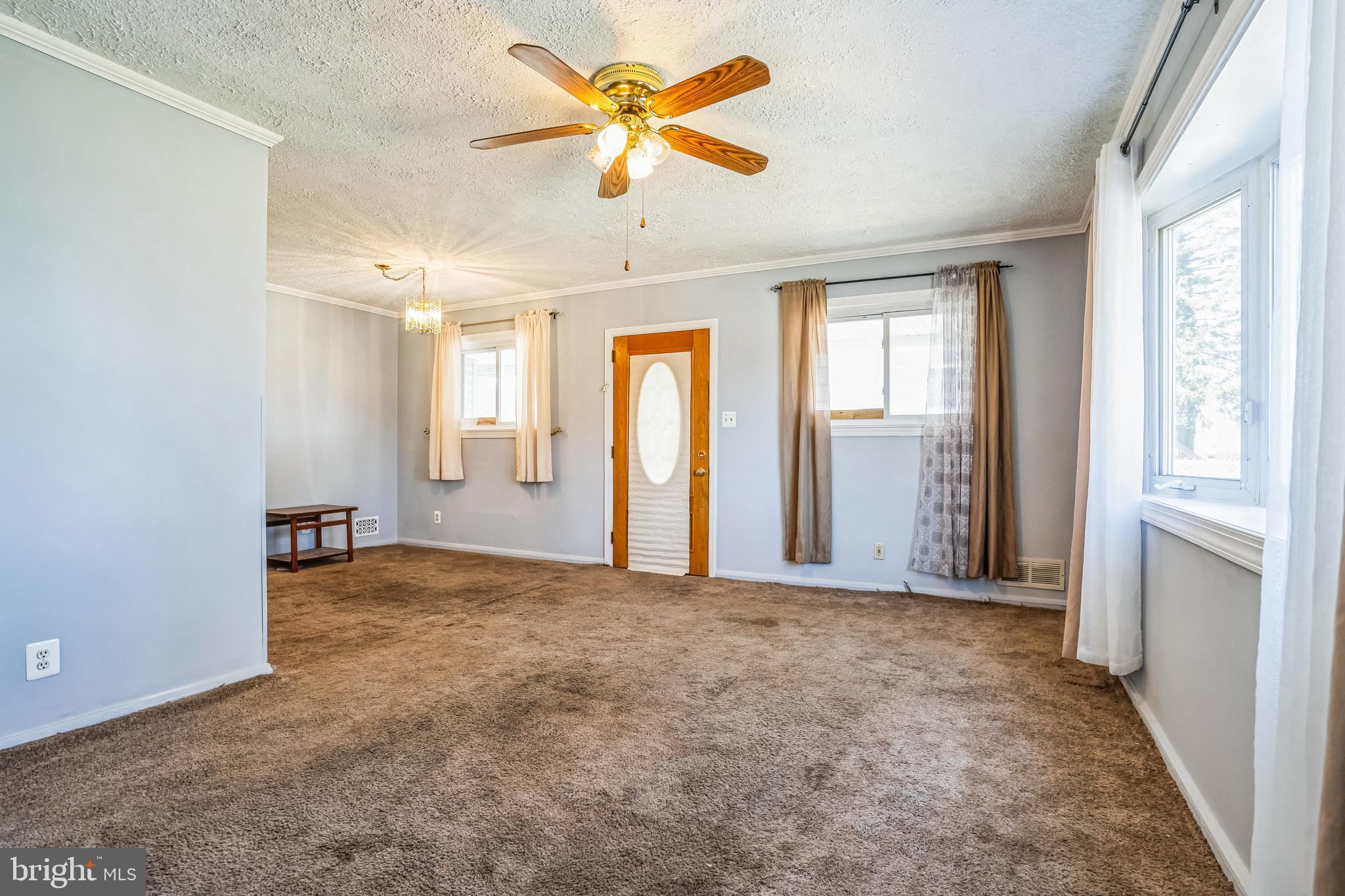 7911 35th Street Rosedale, MD 21237 - Photo 5 of 30 a view of an empty room with chandelier fan and a window