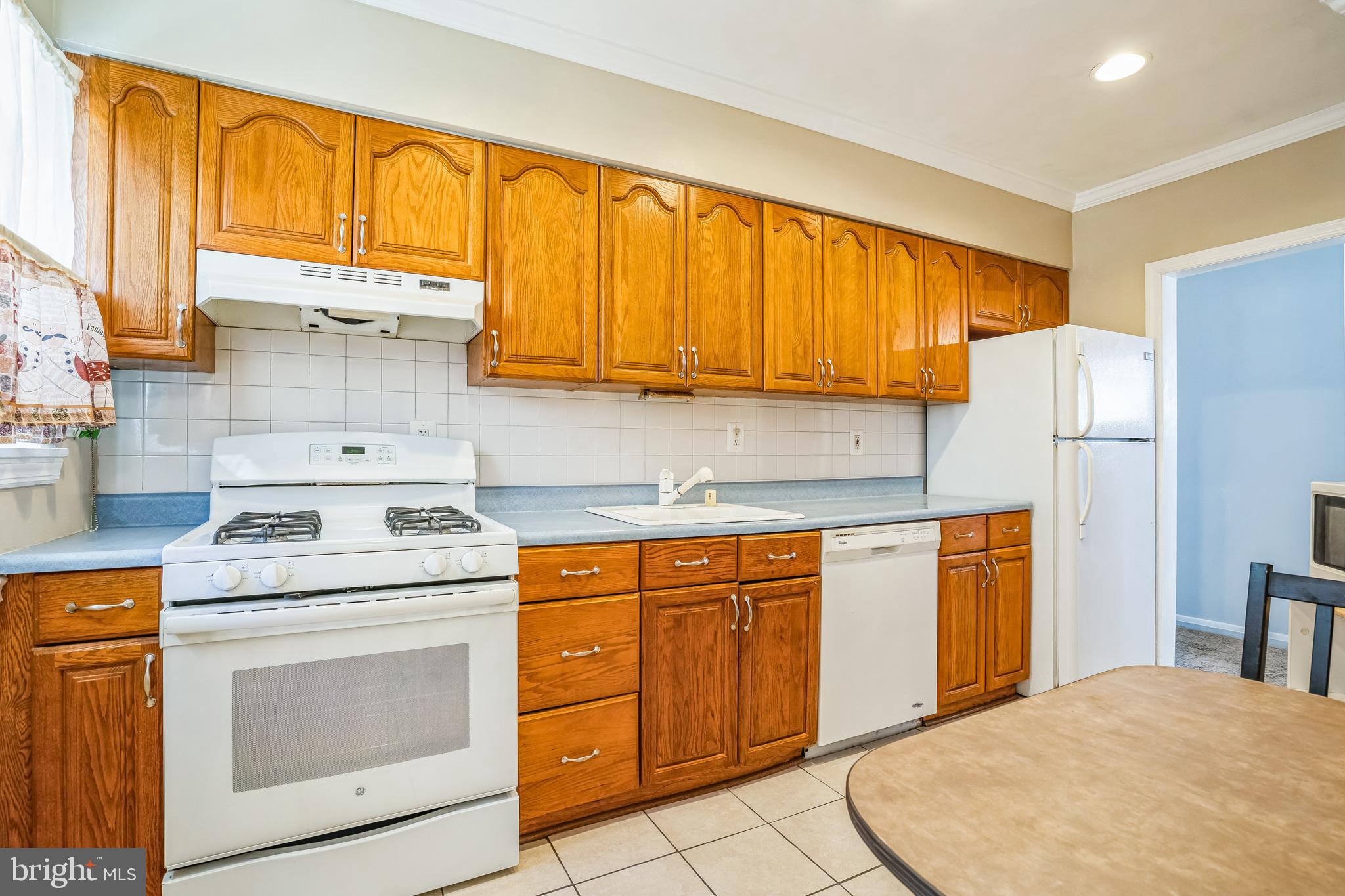 7911 35th Street Rosedale, MD 21237 - Photo 9 of 30 a kitchen with stainless steel appliances granite countertop a stove a sink and a refrigerator