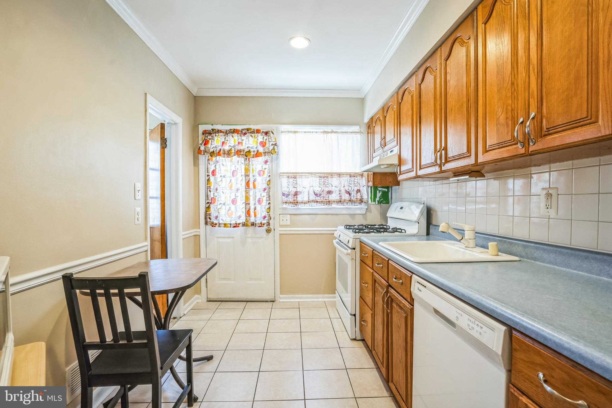 7911 35th Street Rosedale, MD 21237 - Photo 10 of 30 a kitchen with a sink and wooden cabinets
