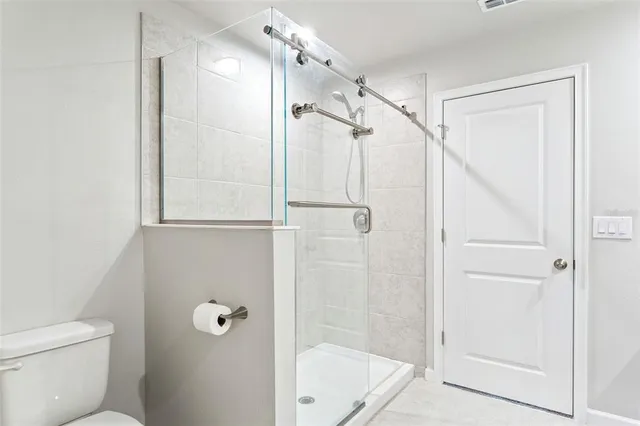 a bathroom with a shower and a toilet