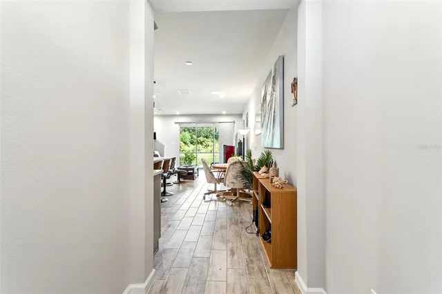 a view of a dinning room with furniture and a potted plant