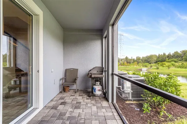 a view of a balcony with chair and front door