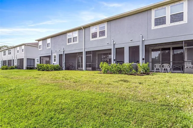 a front view of a building with a garden