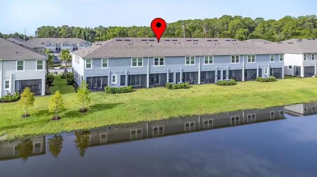 a aerial view of a house with swimming pool and a yard