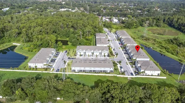 an aerial view of residential houses with outdoor space and street view