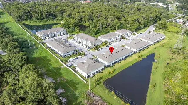 an aerial view of a house with a yard