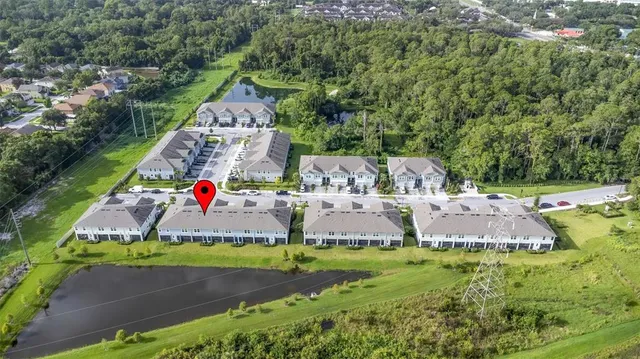 an aerial view of a house with a yard