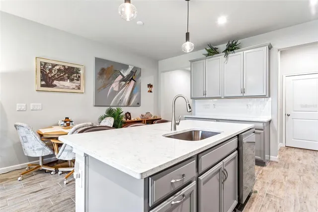 a kitchen with a sink a stove a refrigerator and cabinets
