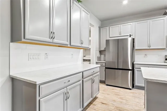 a kitchen with cabinets and stainless steel appliances
