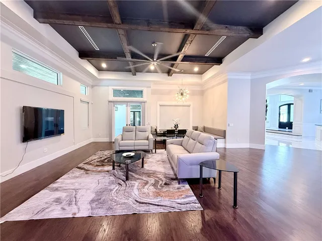 a view of a livingroom with furniture and a flat screen tv