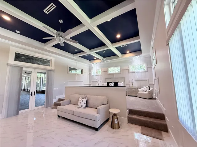 a spacious en suite bathroom with a granite countertop sink a mirror and a shower