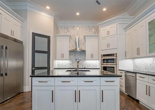 a kitchen with granite countertop a sink and a stove