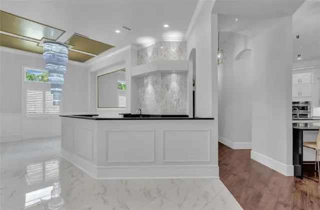a living room with stainless steel appliances kitchen island wooden floors and view living room