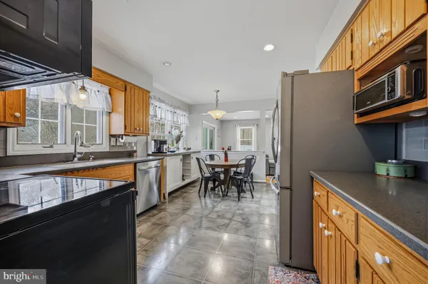 a kitchen with stainless steel appliances granite countertop sink stove and table