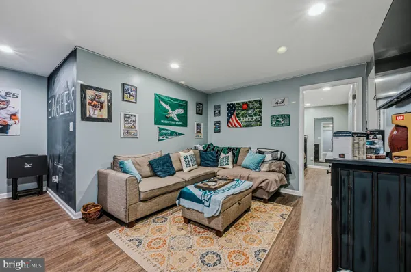 a living room with furniture a couch and kitchen view