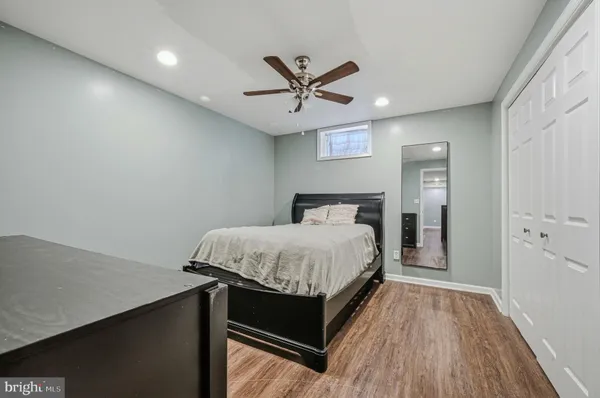 a bedroom with a bed and a ceiling fan