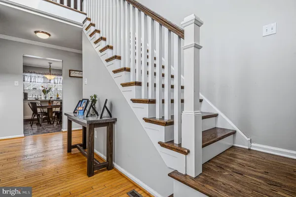 a view of entryway with wooden floor and stairs