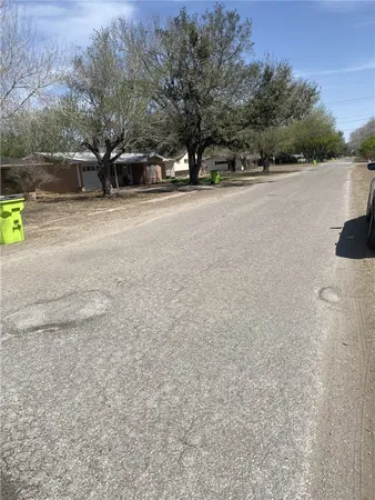 a view of a field with trees in the background
