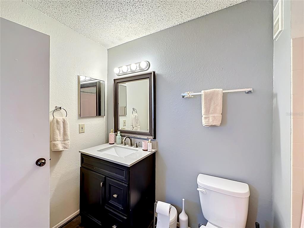 3705 Southwest 27th Street, Unit 922 Gainesville, FL 32608 - Photo 18 of 34 a bathroom with a toilet sink and mirror
