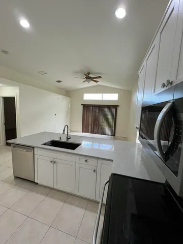 a view of a room with an empty space and floor to ceiling window