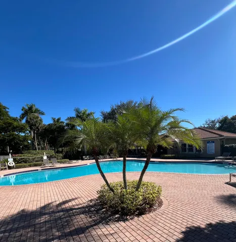 a swimming pool with outdoor seating and yard