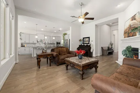 a living room with furniture and a chandelier