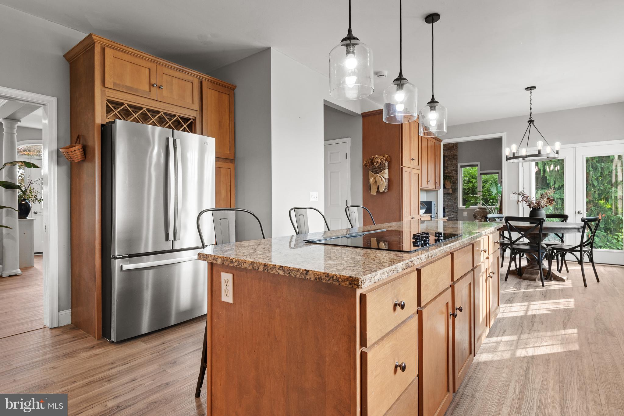 857 Church Road Lebanon, PA 17042 - Photo 15 of 43 a kitchen with stainless steel appliances granite countertop a refrigerator a sink dishwasher a stove and a dining table with wooden floor