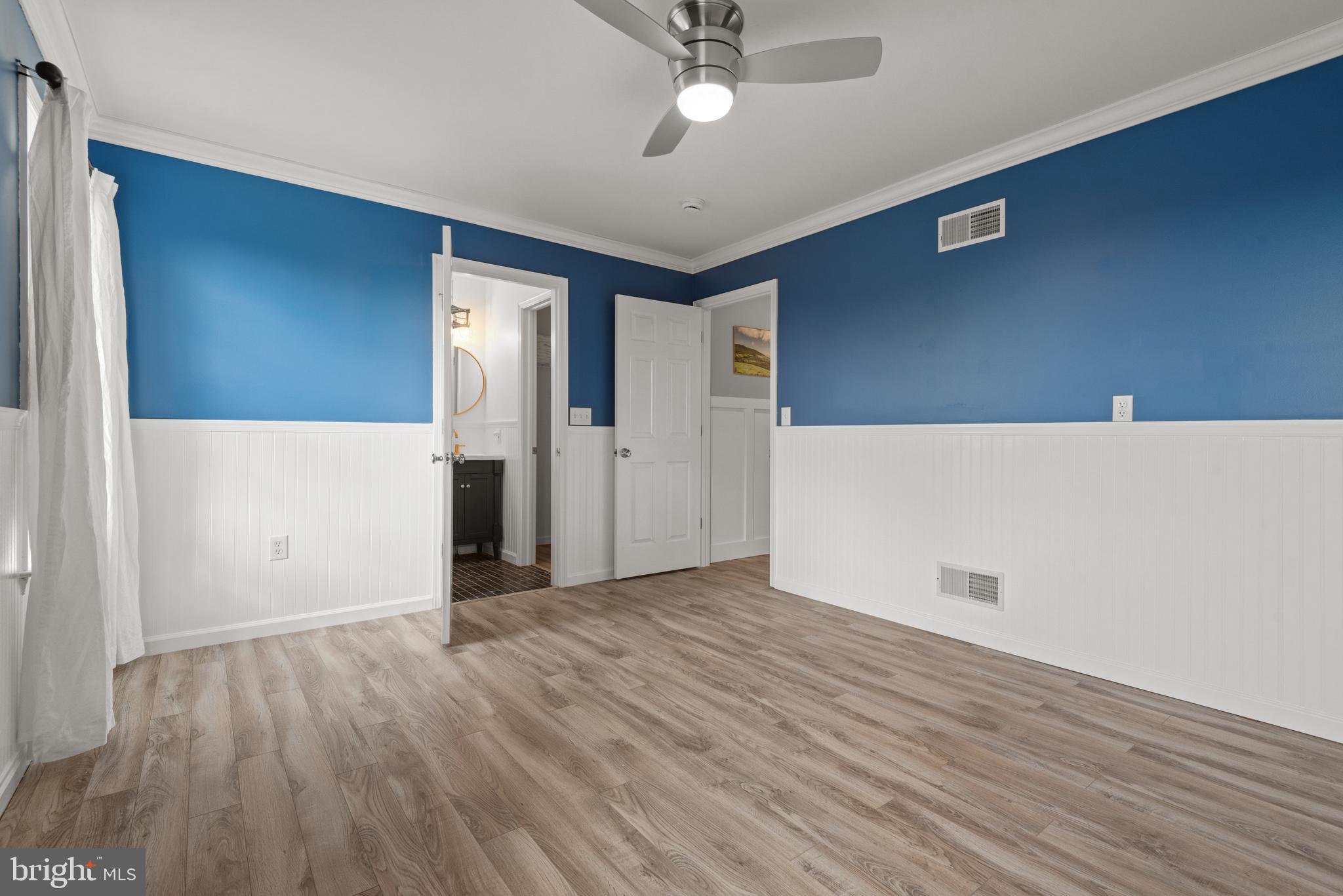 857 Church Road Lebanon, PA 17042 - Photo 31 of 43 a view of an empty room with wooden floor and a ceiling fan