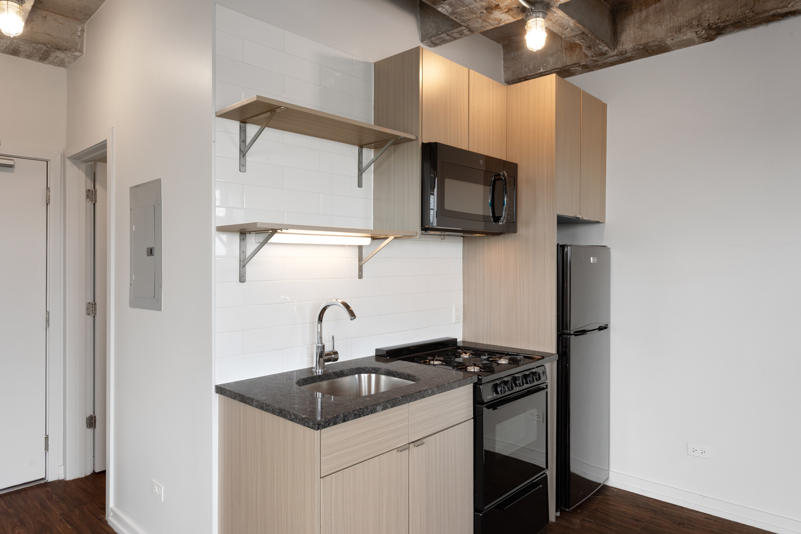 1325 West Wilson Avenue, Unit 1102 Chicago, IL 60640 - Photo 3 of 20 a kitchen with a sink and steel appliances