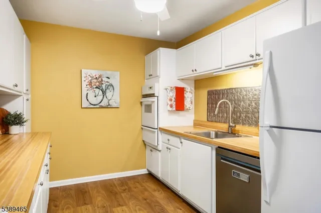 a kitchen with stainless steel appliances a refrigerator sink and cabinets