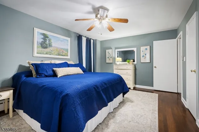 a spacious bedroom with a large bed and a chandelier