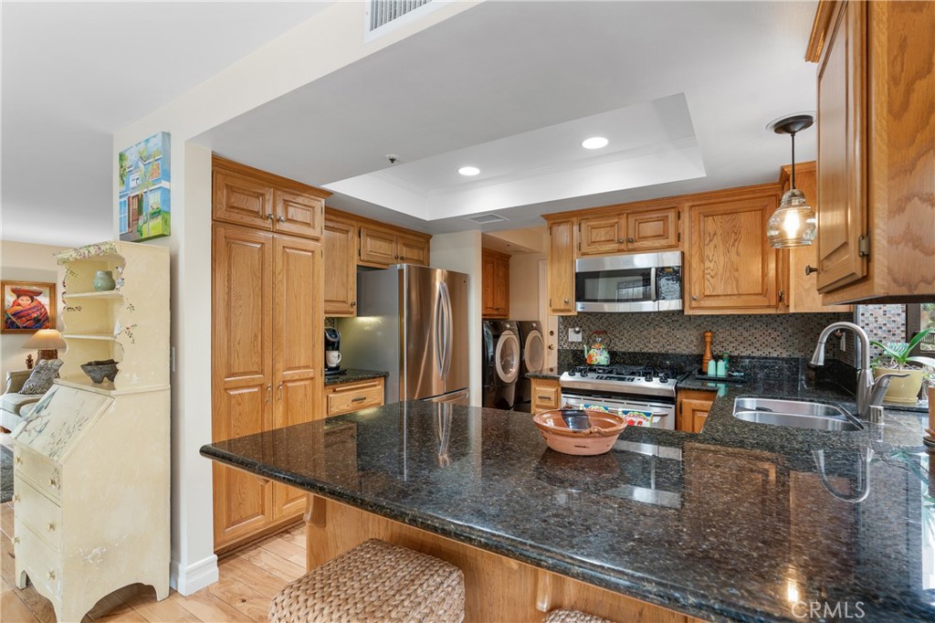 333 Genoa Street, Unit 6 Arcadia, CA 91006 - Photo 11 of 40 a kitchen with stainless steel appliances granite countertop a sink stove and refrigerator