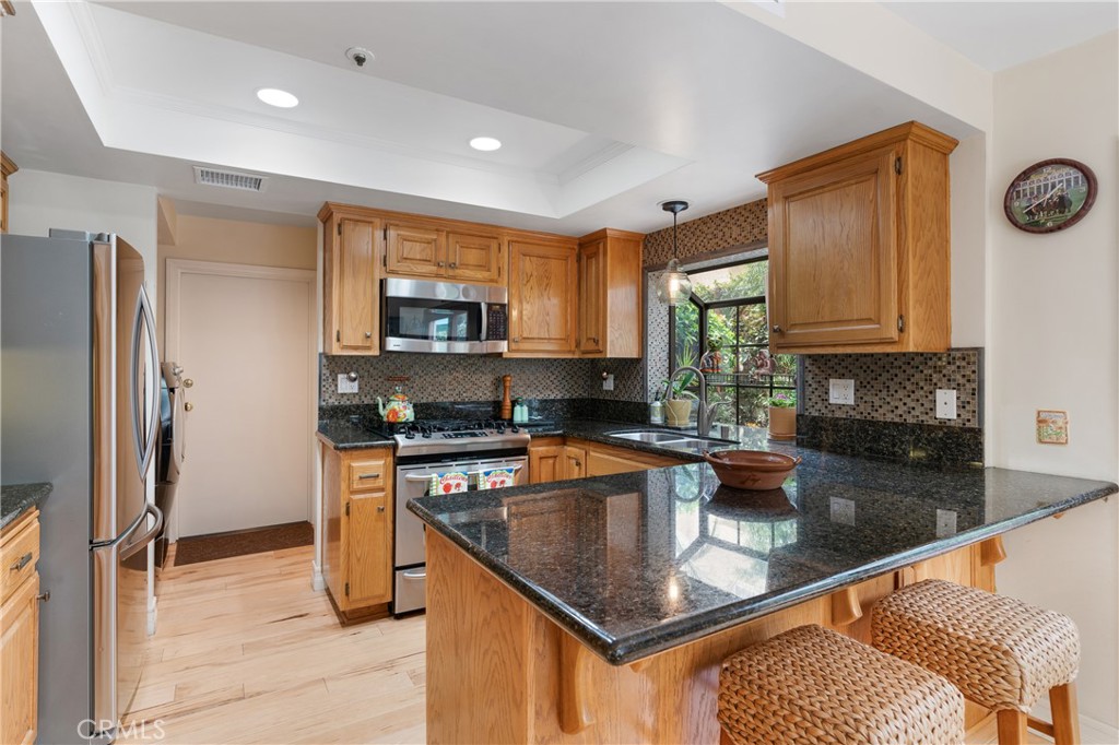 333 Genoa Street, Unit 6 Arcadia, CA 91006 - Photo 12 of 40 a kitchen with a refrigerator a stove a sink and a microwave