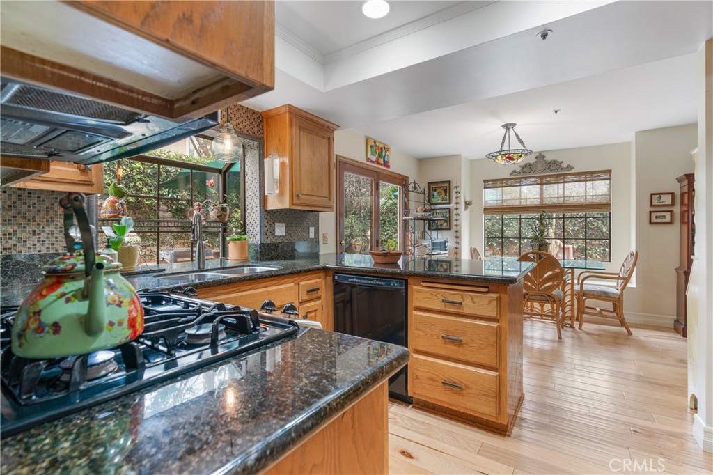 333 Genoa Street, Unit 6 Arcadia, CA 91006 - Photo 13 of 40 a kitchen with stainless steel appliances granite countertop a stove and a view of living room