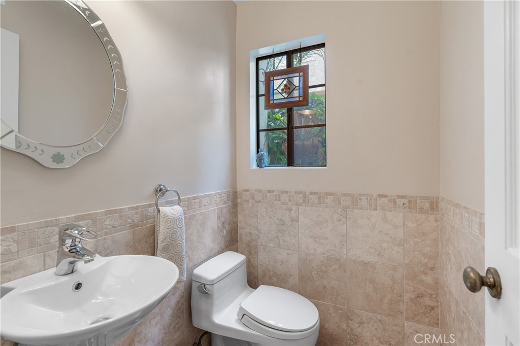 333 Genoa Street, Unit 6 Arcadia, CA 91006 - Photo 16 of 40 a white toilet sitting next to a bathroom sink