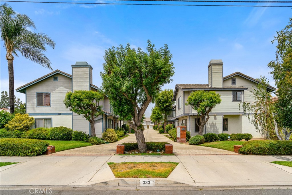 333 Genoa Street, Unit 6 Arcadia, CA 91006 - Photo 38 of 40 a white house with a yard and plants
