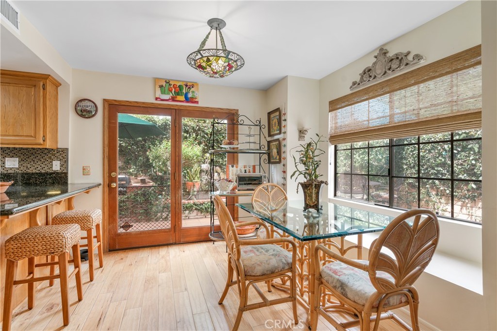 333 Genoa Street, Unit 6 Arcadia, CA 91006 - Photo 8 of 40 a view of a dining room with furniture next chandelier and a large window