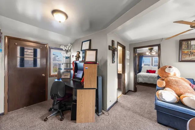 a view of a livingroom with workspace and a window
