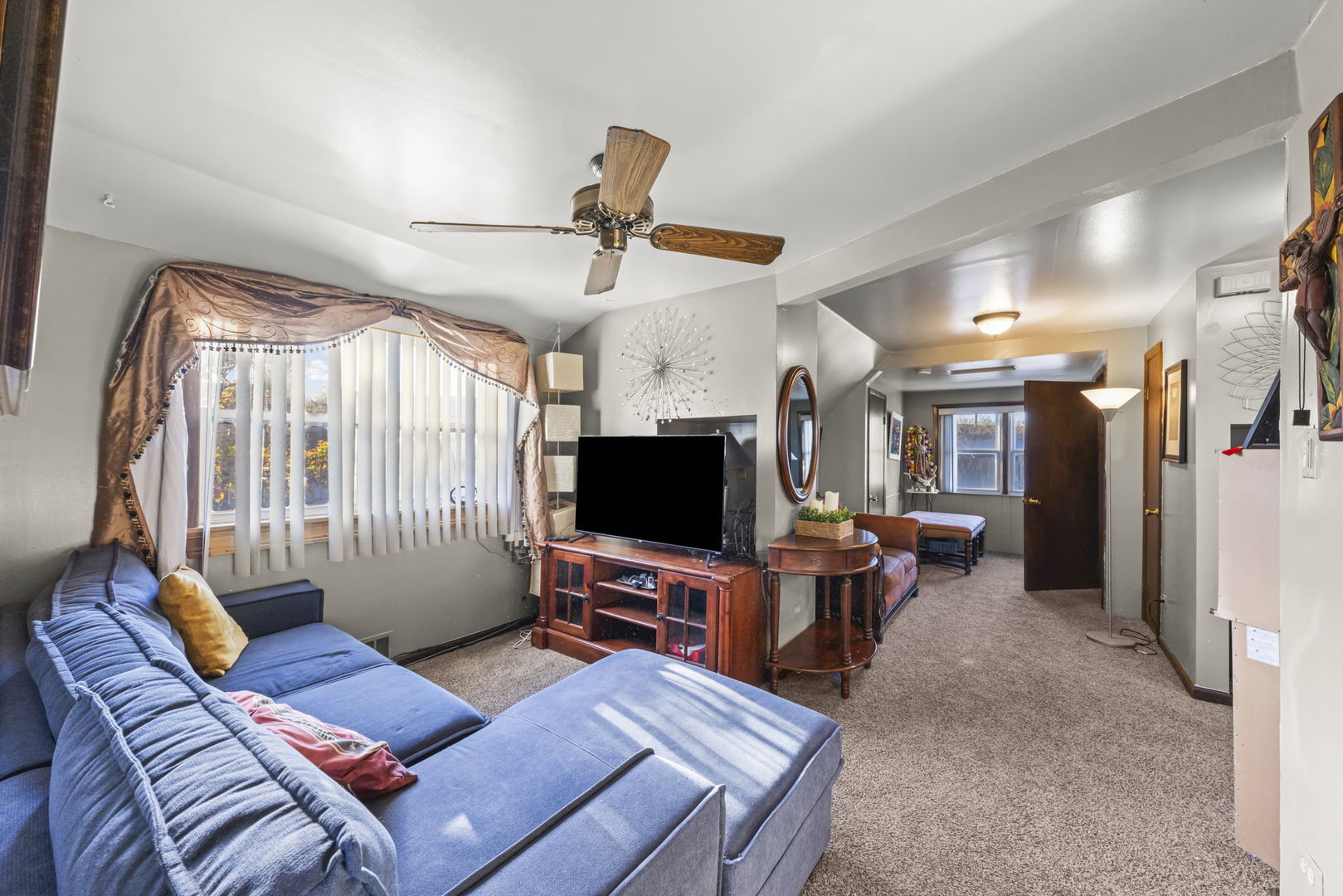 8440 Joliet Road McCook, IL 60525 - Photo 14 of 36 a living room with furniture a flat screen tv and a large window