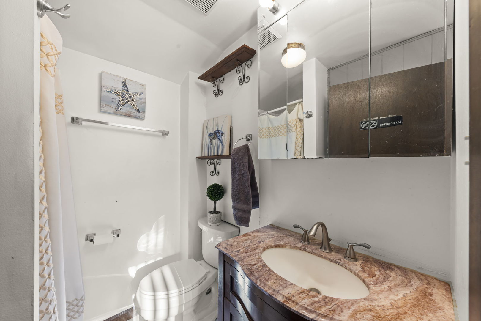8440 Joliet Road McCook, IL 60525 - Photo 17 of 36 a bathroom with a granite countertop sink a toilet and a mirror