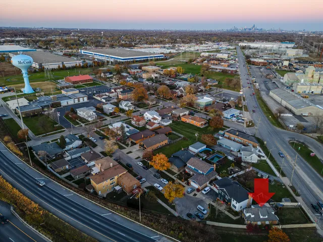 an aerial view of residential houses with city view