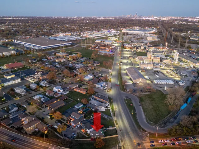 an aerial view of residential houses with city view