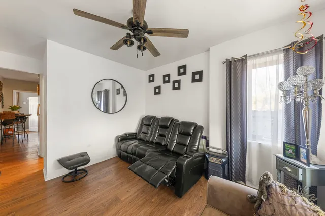 a living room with furniture a window and a clock