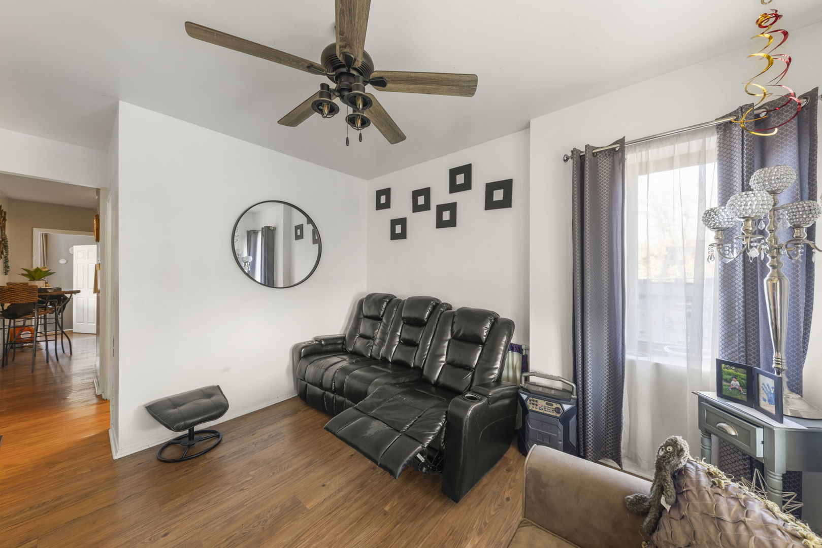 8440 Joliet Road McCook, IL 60525 - Photo 6 of 36 a living room with furniture a window and a clock