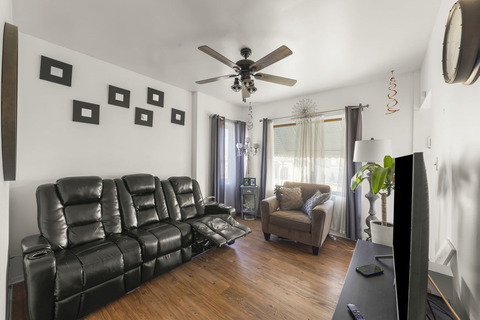 8440 Joliet Road McCook, IL 60525 - Photo 7 of 36 a living room with furniture ceiling fan and a rug