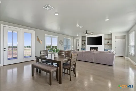 a dining room with furniture and wooden floor