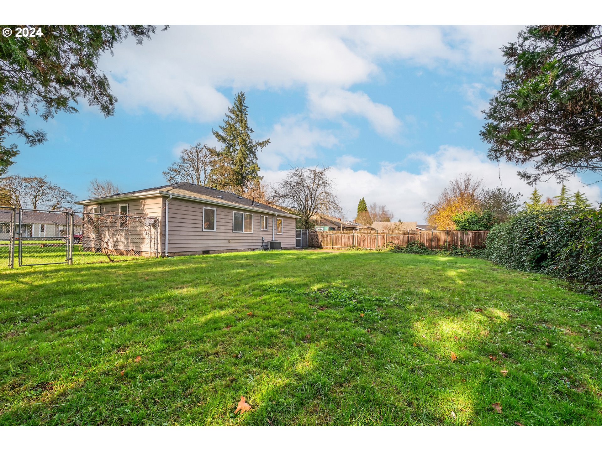 541 Waite Street Eugene, OR 97402 - Photo 20 of 25 a view of a big house with a big yard and large trees