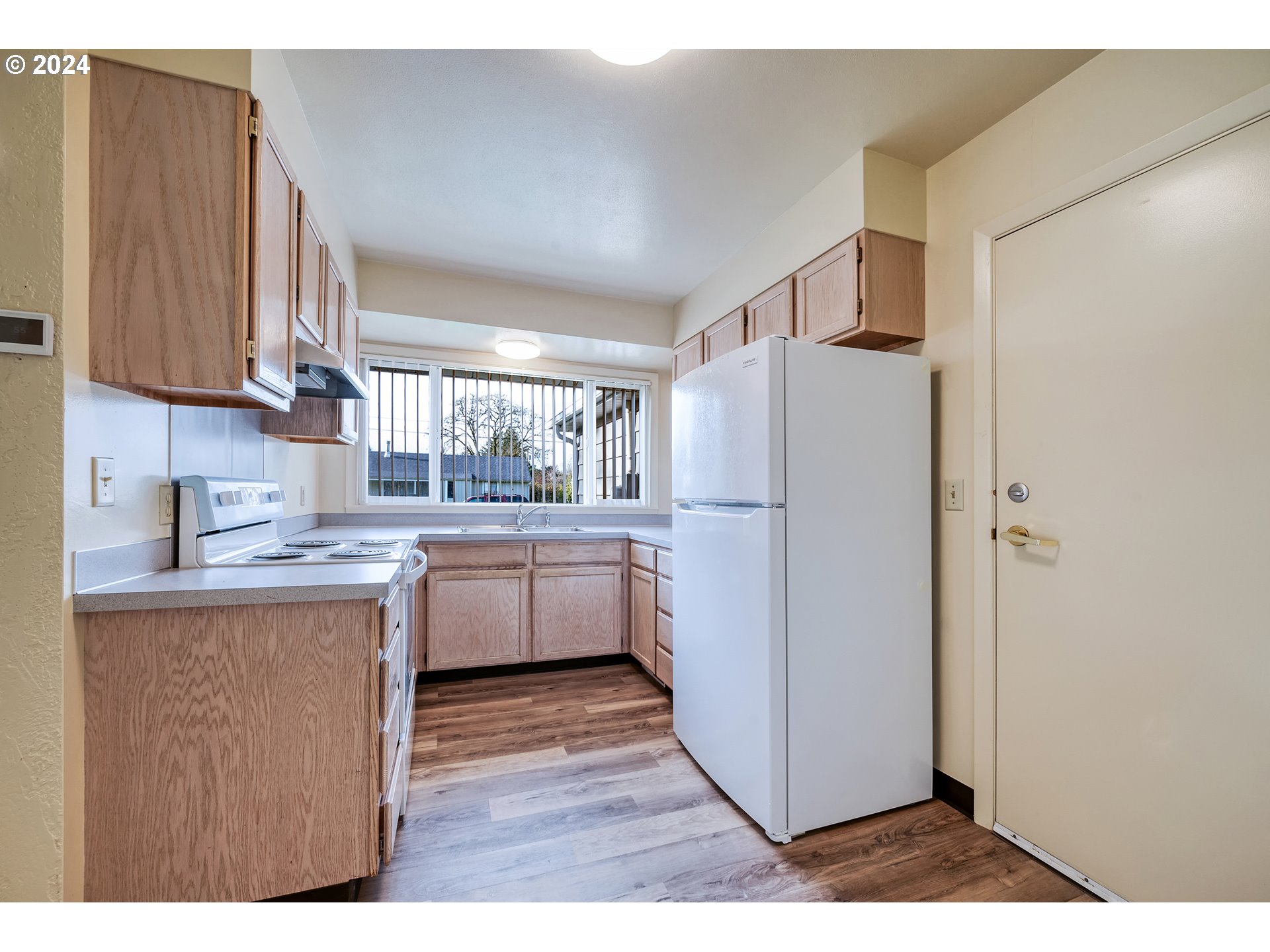 541 Waite Street Eugene, OR 97402 - Photo 10 of 25 a kitchen with a refrigerator a stove top oven a sink and dishwasher
