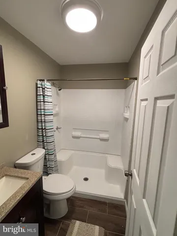 a bathroom with a toilet and a shower